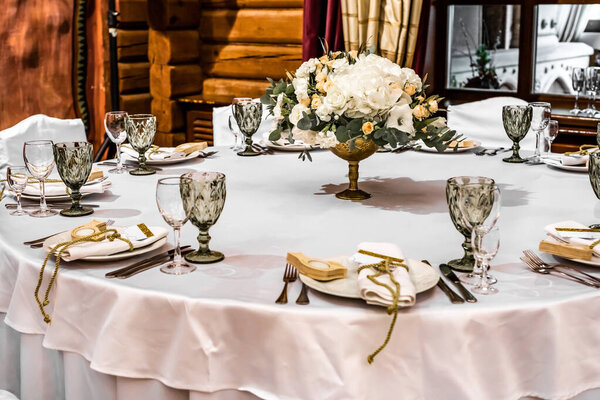 White wedding decoration in restaurant. Luxury wedding arrangement. Wedding banquet decoration. Tables in restaurant decorated with beautiful white peonies and roses