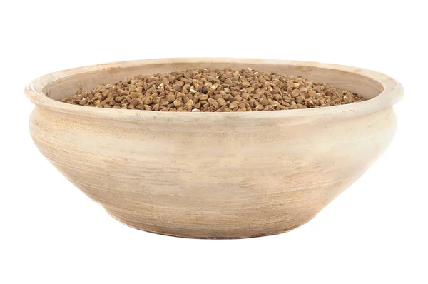 Dry buckwheat in clay bowl isolated on white — Stock Photo, Image