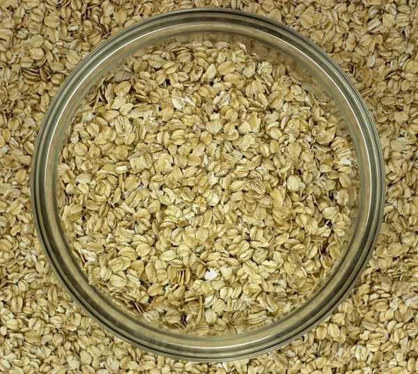 Dry oat flakes oatmeal in bowl on the background — Stock Photo, Image