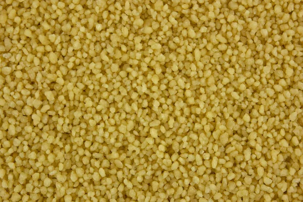 Raw organic couscous background — Stock Photo, Image