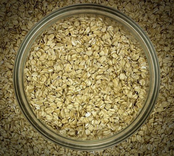 Dry oat flakes oatmeal in bowl on the background — Stock Photo, Image