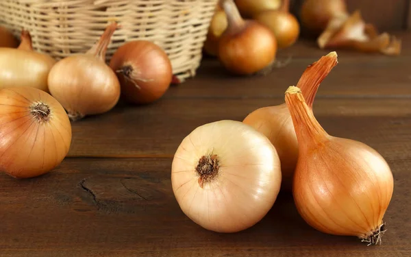 Çiğ soğan bir ahşap masa ve sepeti