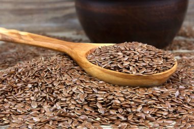 Kase üzerinde ahşap dağınık tahıllar ile keten tohumu wi arka plan