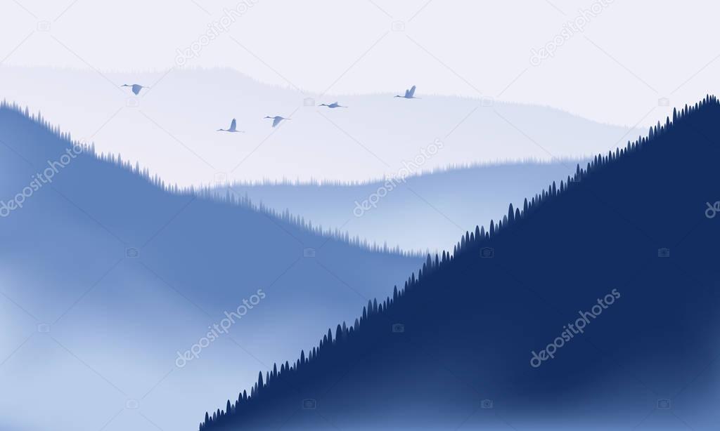flock of cranes flying above wooded mountains