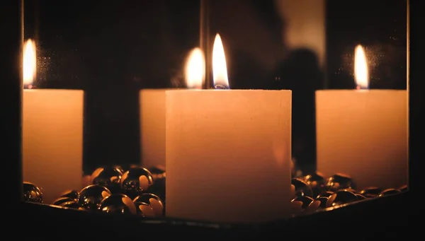 Christmas candle between mirrors — Stock Photo, Image