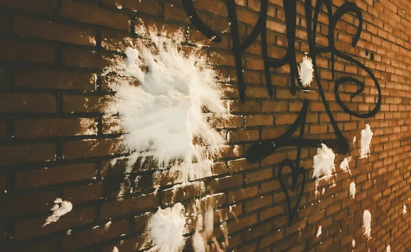 Snöboll träffa en tegelvägg med graffiti — Stockfoto