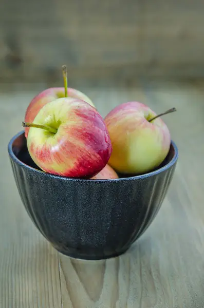 Kırmızı ve sarı apple siyah kase ile — Stok fotoğraf