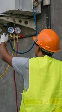 Teknisyen açık klima ünitesi kontrol ediyor
