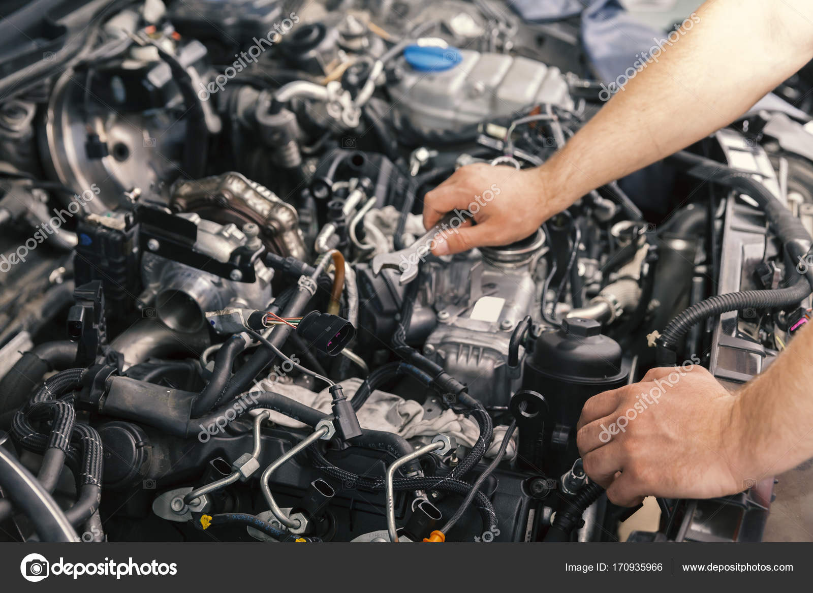 Mechanic working on engine repairs Stock Photo by ©DJSrki 170935966