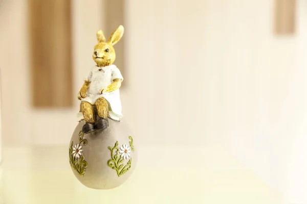 Rabbit sitting on egg, easter decoration with copy space — Stock Photo, Image