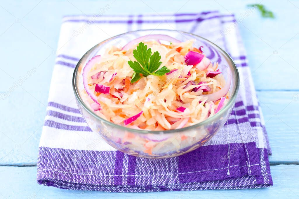 Homemade sauerkraut salad with red onion and carrot