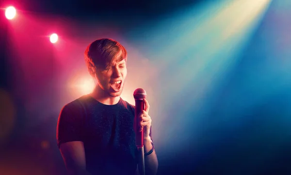 Singer with microphone in spotlight. Music performance