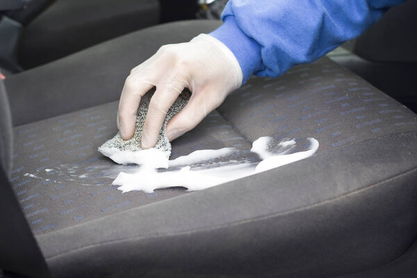 Hand in the glove protects the seat upholstery of the car seat with foam.