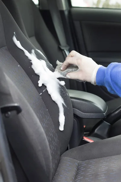 Hand in the glove protects the seat upholstery of the car seat with foam.