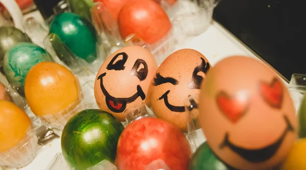 Easter eggs with face expressions. Male and female face. Easter egg hunt, family bonding and celebration concept.