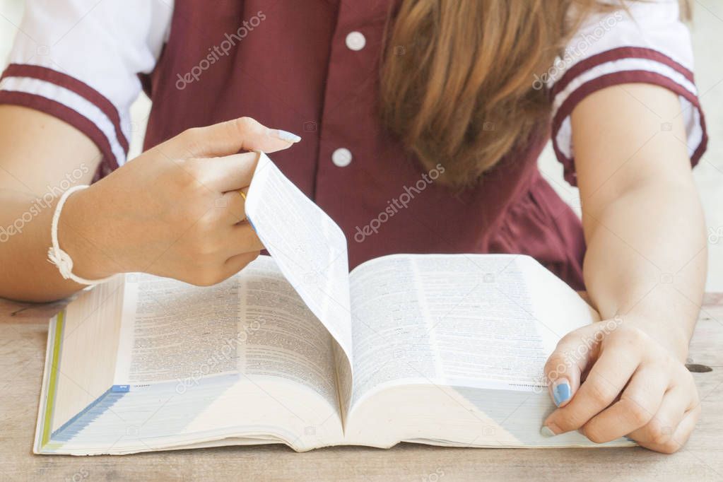 woman reading a book dictionary english for study