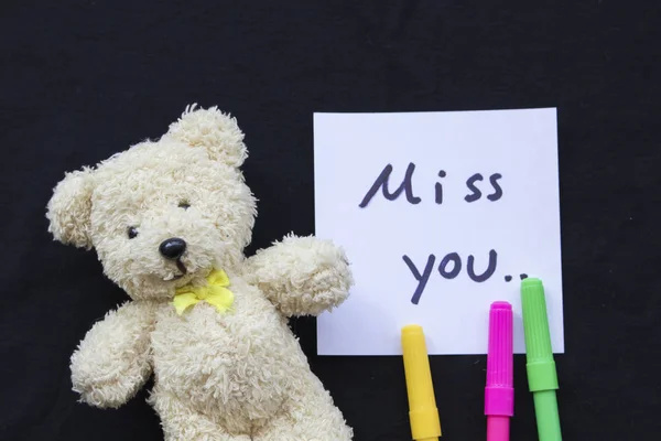 miss you message card with teddy bear on black