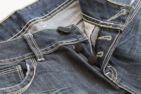 Bakgrunden texturerat knappar jeans byxor denim tyg — Stockfoto