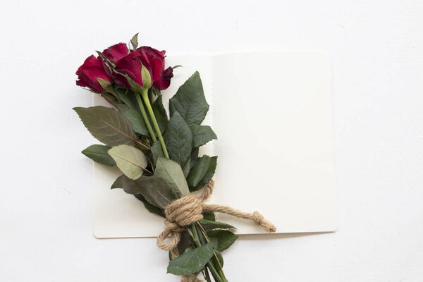 bouquet of flower red rose with notebook on background white