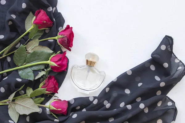 accessories of lifestyle woman perfume with black scarf and red rose