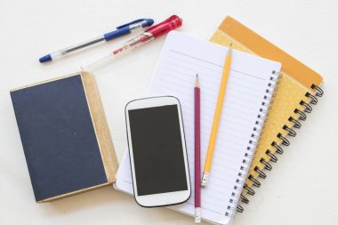 Eğitim defter kitapla ve mobil hazırlamak tablo beyaz üzerinde çalışma