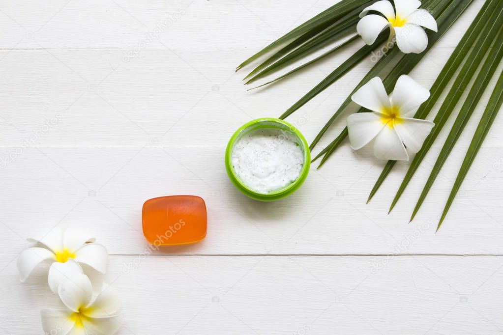 natural herbal coconut scrub health care for surface skin face with herbal soap for cleaner ,coconut leaf ,flowers frangipani arrangement flat lay style on background white 