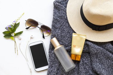 sunscreen spf50 ,toners serum therapy cosmetics health care for skin face with knitting wool sweater ,sunglasses ,mobile and hat of lifestyle woman in winter season arrangement flat lay style