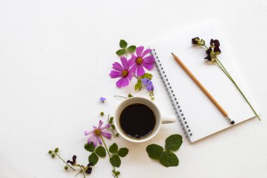 notebook planner for business work with hot coffee espresso  ,pink flowers cosmos arrangement flat lay style on background white 