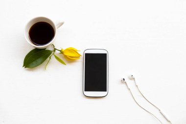 Cep telefonu, ofis düzeninde hayat tarzının sıcak kahve espresso arka planda beyaz bir şekilde yatıyordu. 