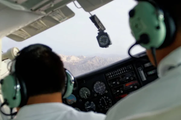 Pilots in plane cockpit