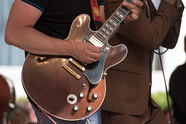 outdoor concert, musician playing guitar