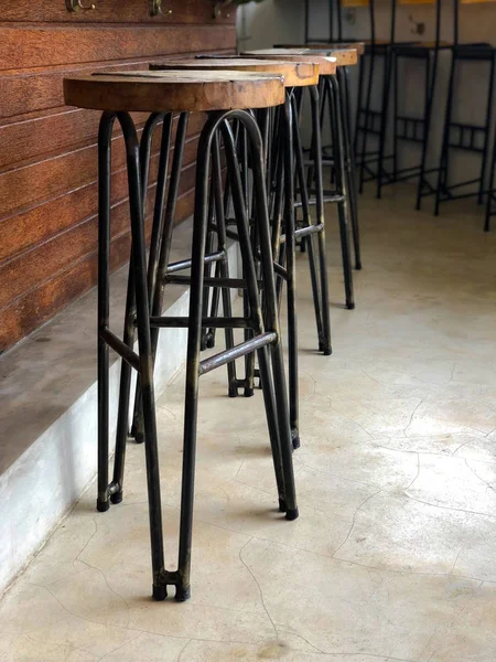 High bar stools stand near the bar counter. Everything is symmetrical and in lines.