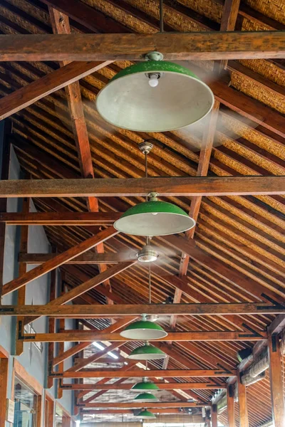 Wooden ceiling with round lamps and fans