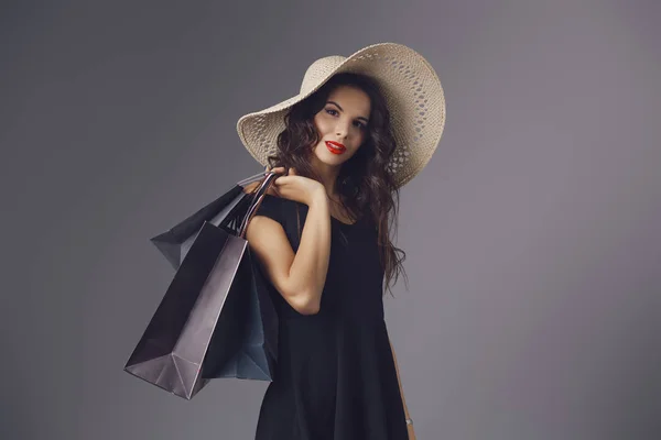 Jeune femme en robe noire élégante et chapeau d'été — Photo