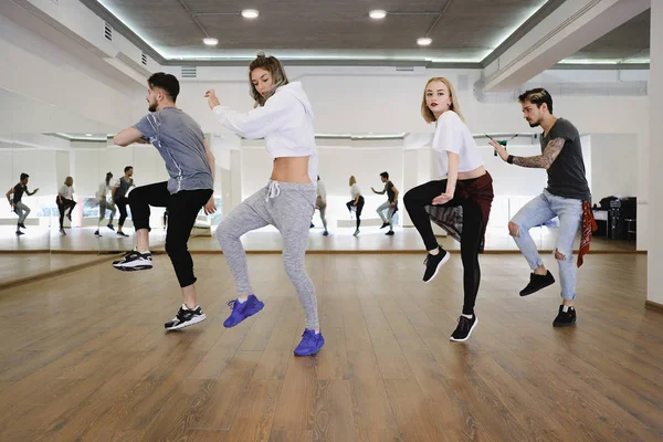 Group of young modern dancers dancing in the studio