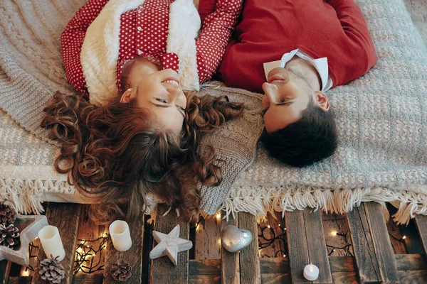 Pareja joven acostada en la cama sonriendo con la cabeza al revés — Foto de Stock