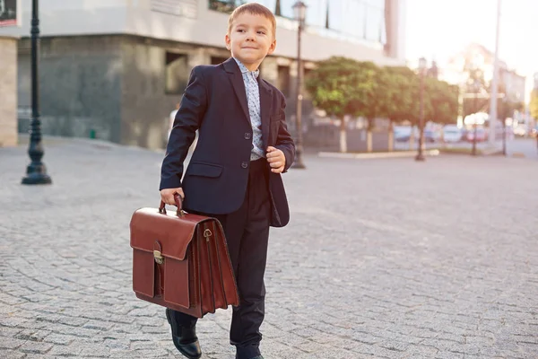 Future businessman in formal costume with briefcase