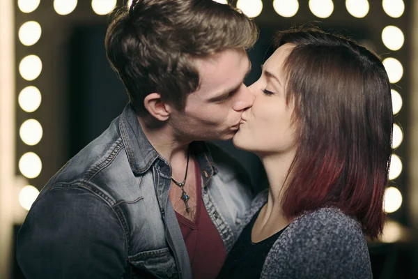 Beautiful couple kissing with lights in background — Stock Photo, Image