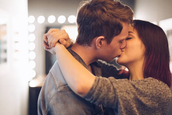 Beautiful couple kissing with lights in background — Stock Photo, Image