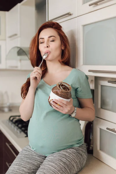 Donna incinta godendo mangiare cioccolato — Foto Stock