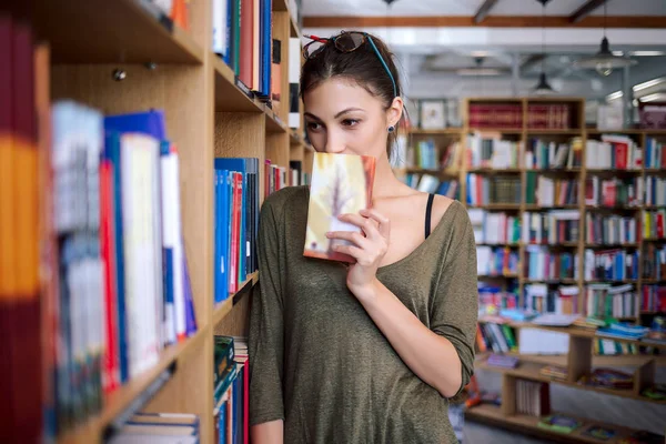 Young simpatic woman looking interested to books