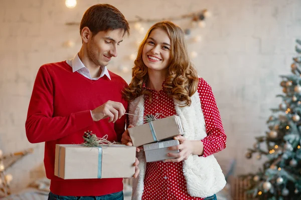 Happy young couple with Christmas presents — Stock Photo, Image