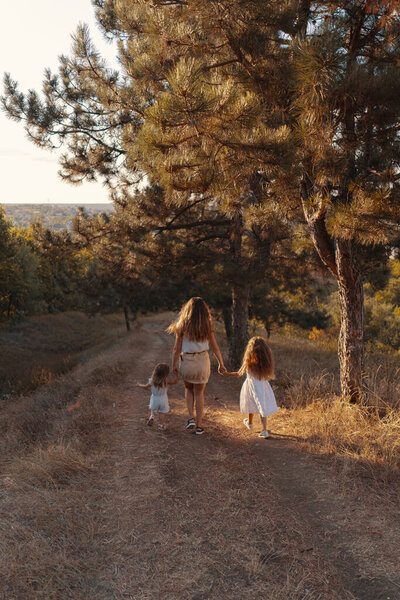 Happy mother playing with her daughters