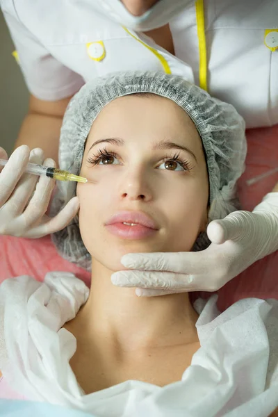 Beautiful young girl of European appearance on the procedure of injecting — Stock Photo, Image