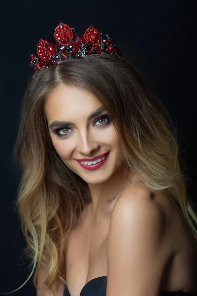 portrait of beautiful young girl with makeup and hairdo with crown