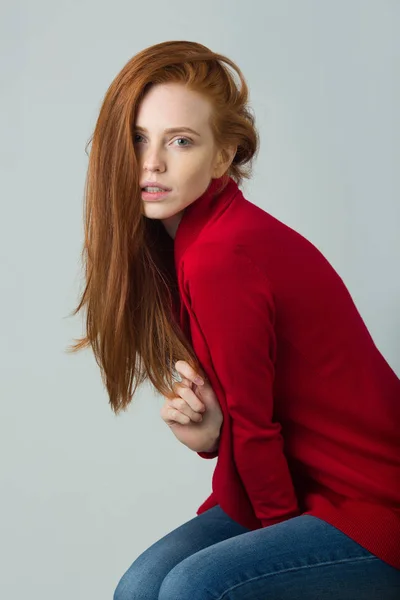 Beautiful young girl with red hair in a red — Stock Photo, Image