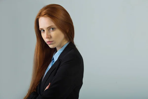 Beautiful young girl with red hair in a black jacket — Stock Photo, Image