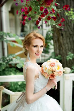 parkta bir düğün buket ile güzel bir genç gelin portresi