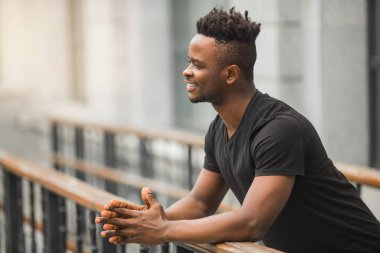 Siyah tişörtlü yakışıklı Afrikalı genç adam.