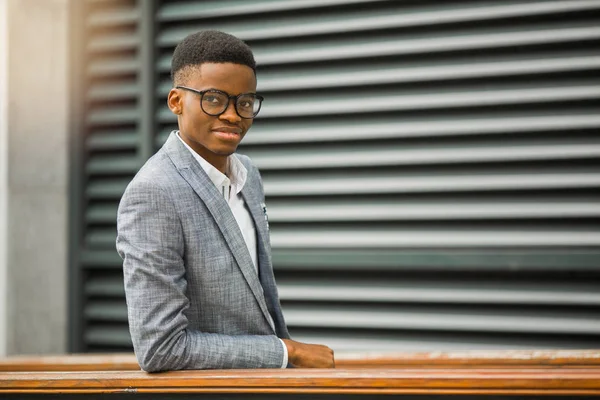 handsome young african man in suit wearing glasses